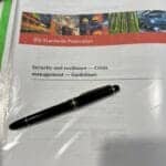 ISO 22361 security and resilience guidelines document with pen.