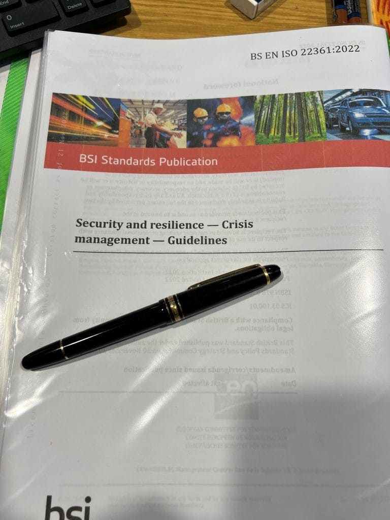 ISO 22361 security and resilience guidelines document with pen.