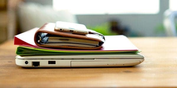 Laptop with files and smartphone for GDPR employee training.