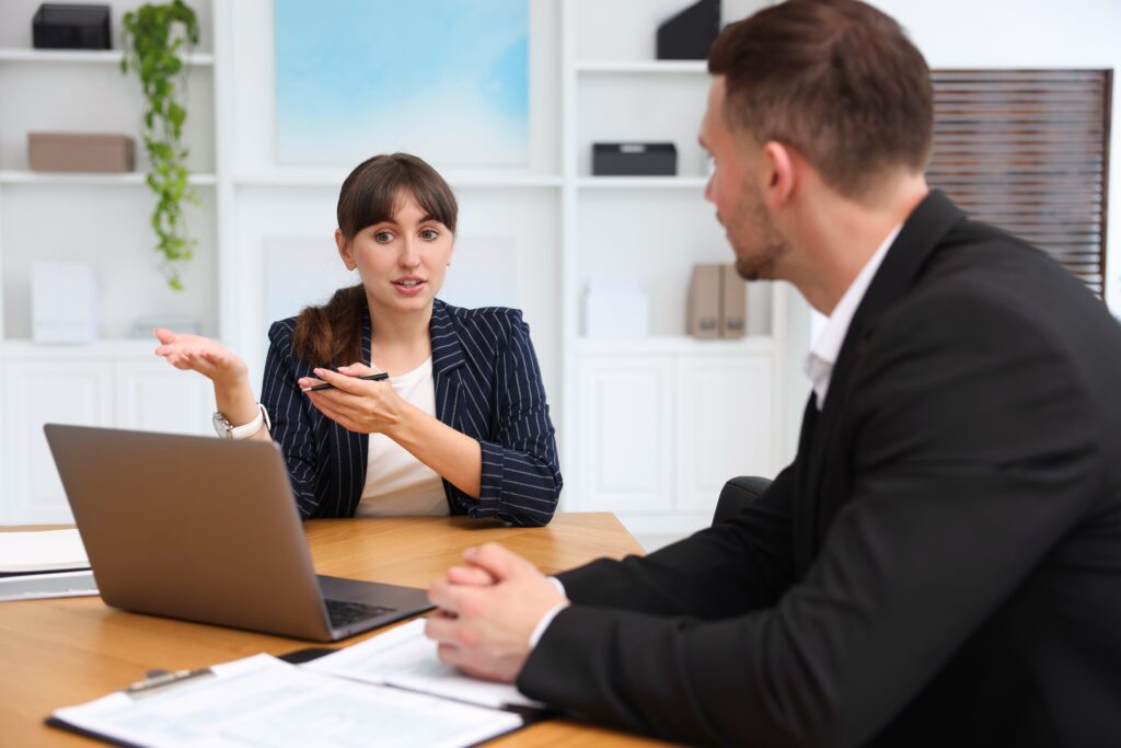 A business continuity consultant explaining options to a client during a planning meeting