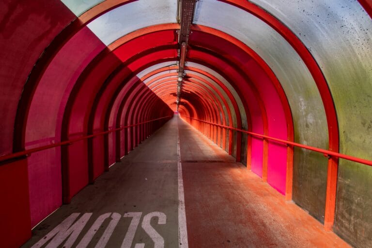 Covered walkway to the SEC, Hydro and Armadillo arenas in Glasgow, with green mould and slime staining the outer panels